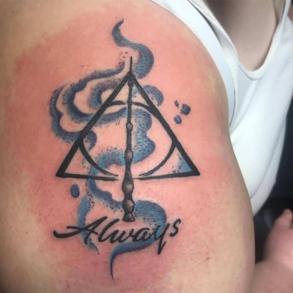 Deathly Hallows tattoo with a blue smoky Patronus effect and 'Always' written below, symbolizing love, loyalty, and Harry Potter magic