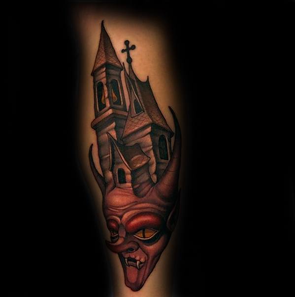 Tattoo of a haunted house morphing into a red devilish face with horns, sharp teeth, and glowing eyes for a bold demonic effect.