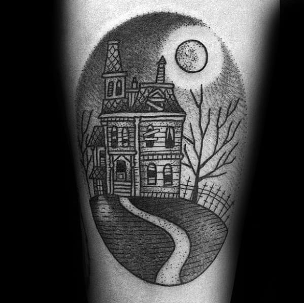 Dotwork tattoo of a haunted house with a winding path, full moon, bare tree, and eerie fence, creating a spooky night scene.