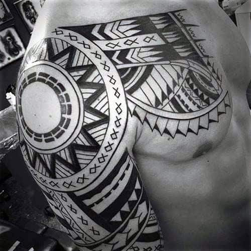 Hawaiian Chest And Half Sleeve Badass Tribal Tattoo Design On Man