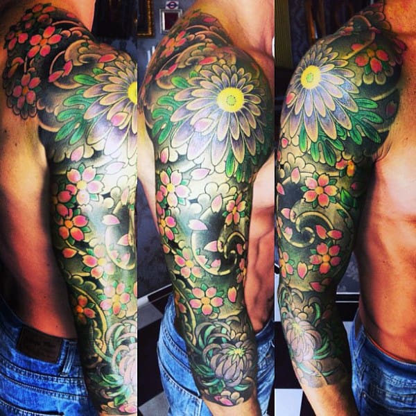 Colorful floral tattoo sleeve on a person's arm, showcasing various flowers and leaves