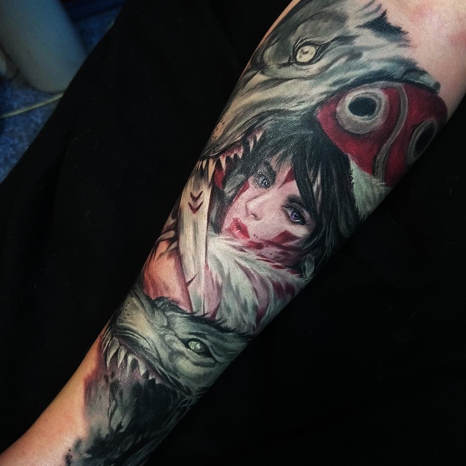 Realistic forearm tattoo of San with intense eyes, blood markings, her wolf pelt, and mask, surrounded by Moro in a dynamic design.