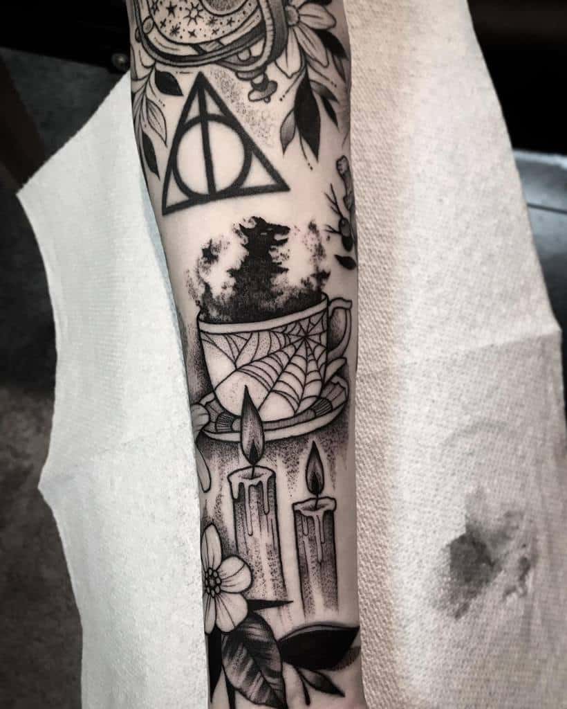 Harry Potter-themed tattoo featuring the Deathly Hallows symbol, a teacup with a grim omen, candles, and floral details