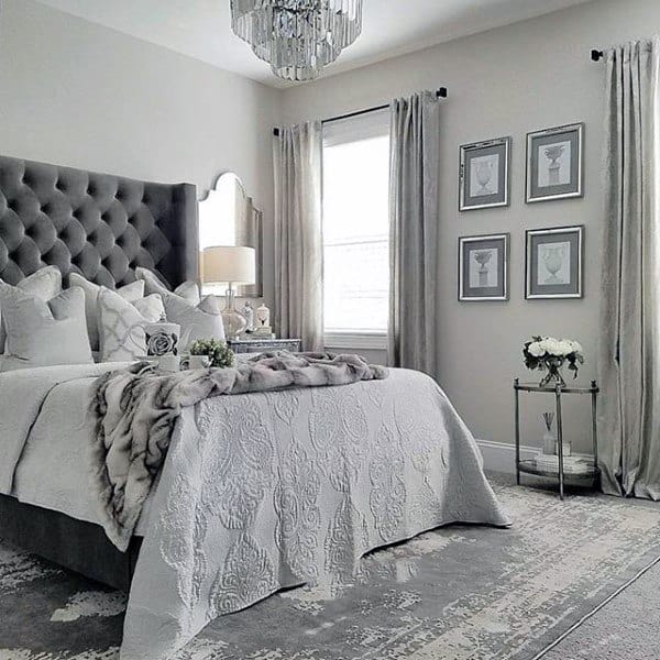 elegant master bedroom chandelier upholstered gray headboard