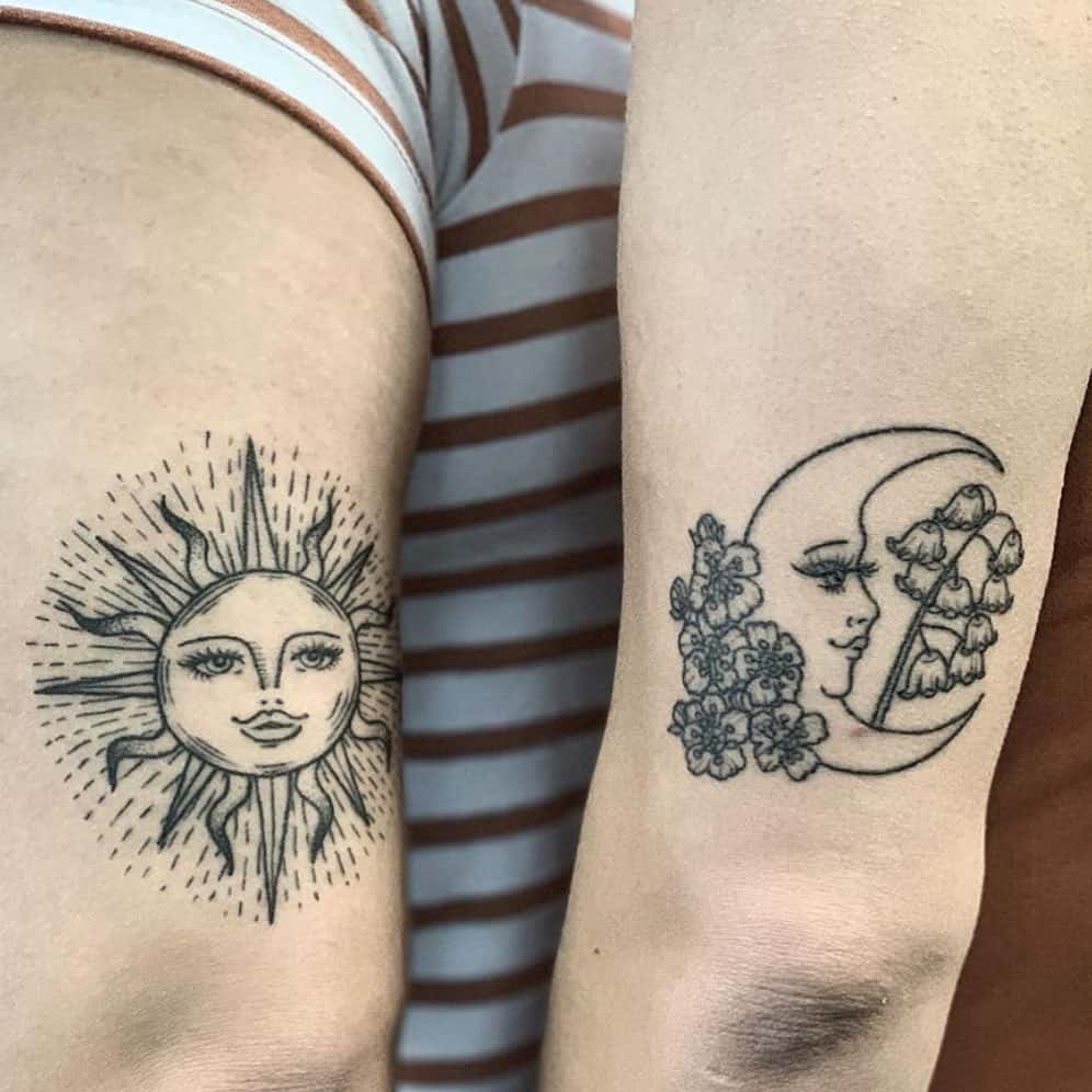 Matching sun and moon sister tattoos one featuring a radiant sun with a face, the other a crescent moon with floral details