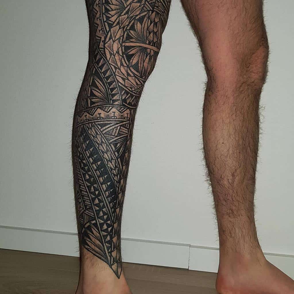 Tribal leg sleeve tattoo featuring geometric patterns and intricate designs