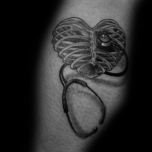 Stethoscope tattoo with a heart-shaped ribcage design, symbolizing a deep connection to healthcare, anatomy, and the medical profession.