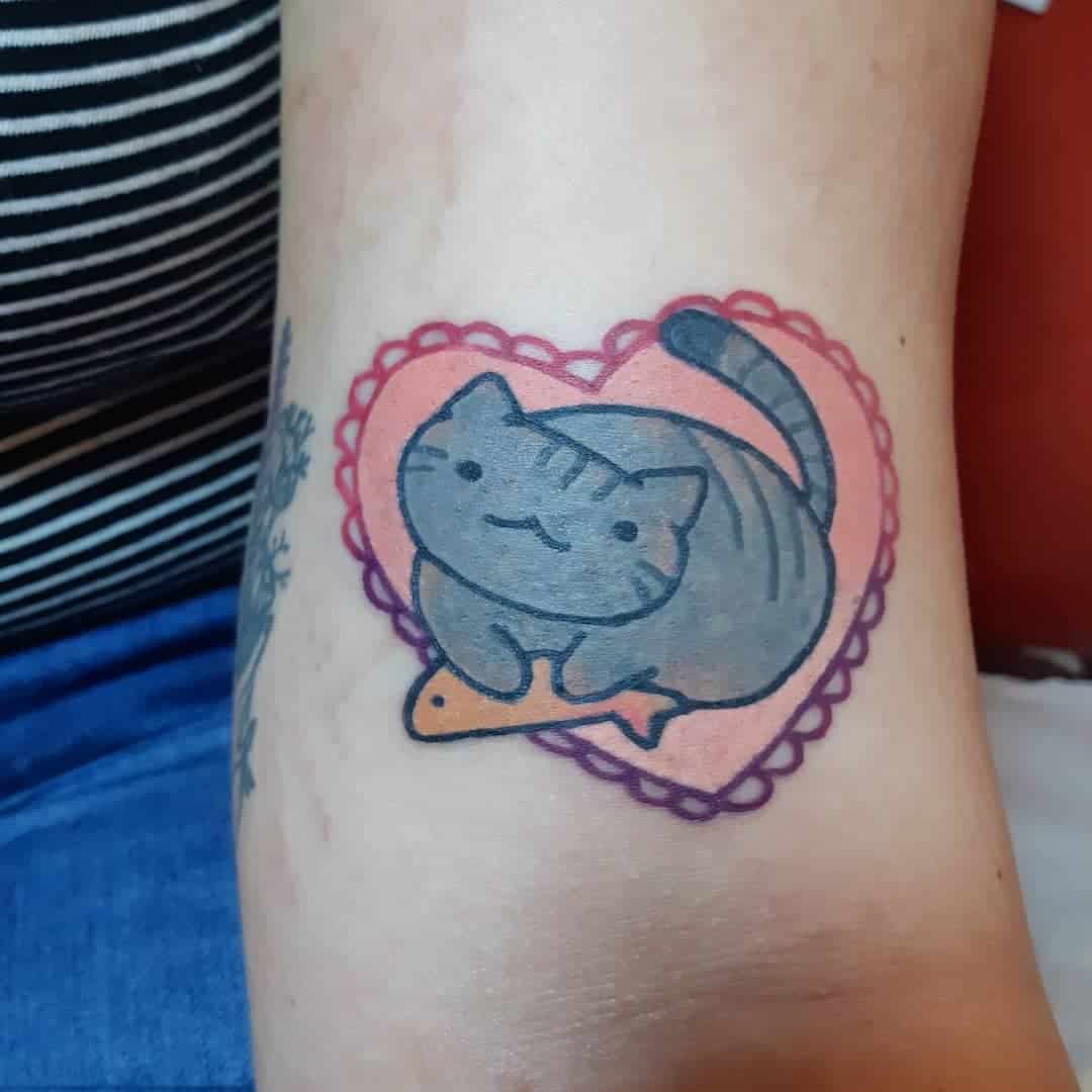 Tattoo of a cute gray cat with a fish, inside a red heart outline