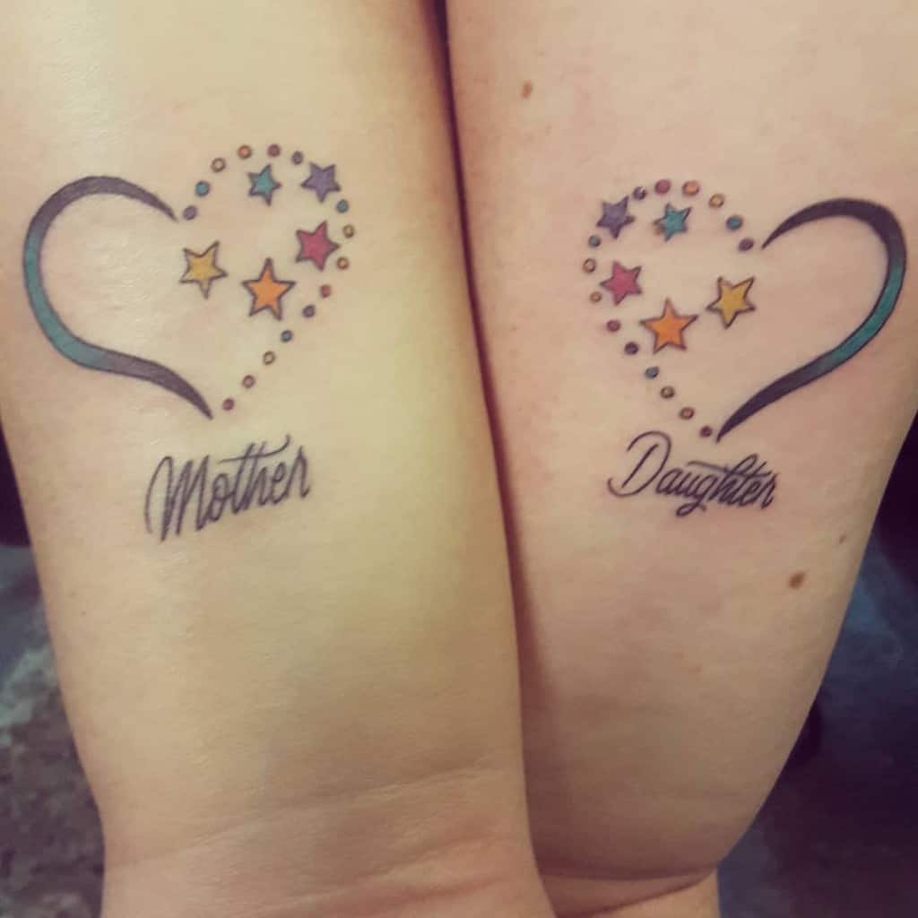 Matching mother-daughter tattoos featuring heart outlines, colorful stars, and cursive text