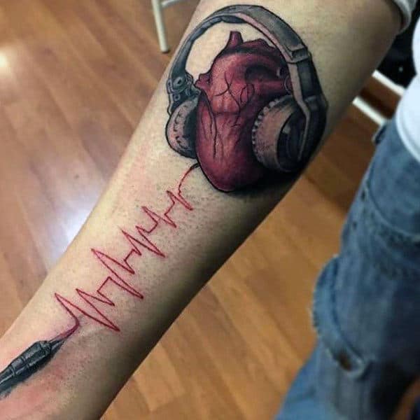 Realistic heart tattoo with headphones and an audio cable forming a heartbeat line