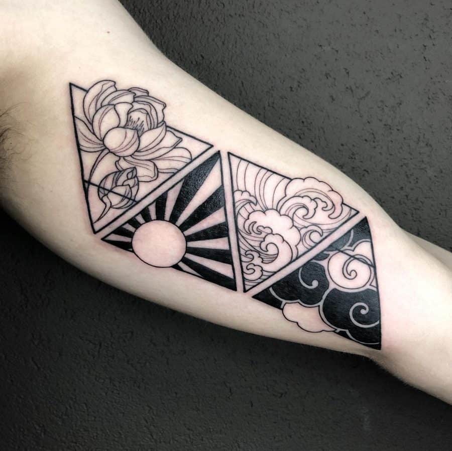 Forearm tattoo featuring three geometric triangles with floral, sun, and cloud motifs, blending Japanese-inspired elements in a bold design.