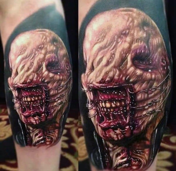 Hyper-realistic *Hellraiser* tattoo of a grotesque, skinless Cenobite with exposed muscle, stitched mouth, and intense shading for a horrifying effect.