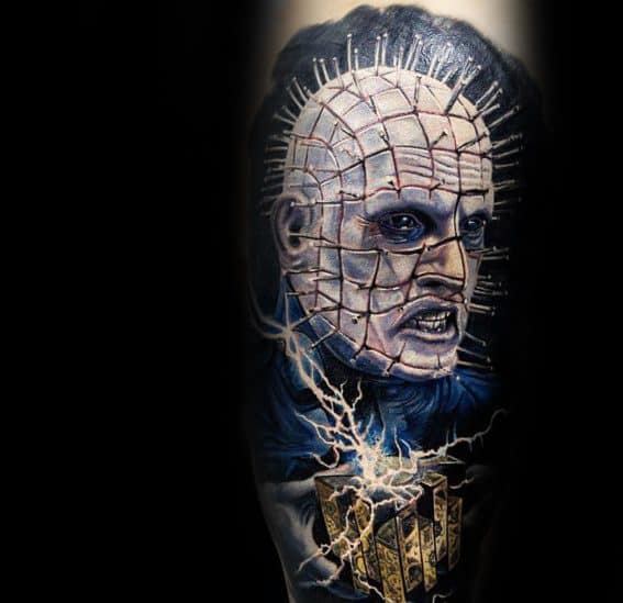 Realistic *Hellraiser* tattoo of Pinhead with eerie blue tones, intricate pin details, the Lament Configuration, and electrifying energy effects.