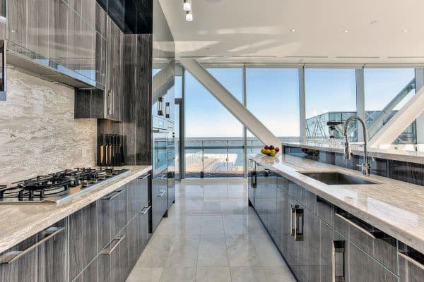luxury kitchen with high gloss woodgrain cabinets and granite bench tops 