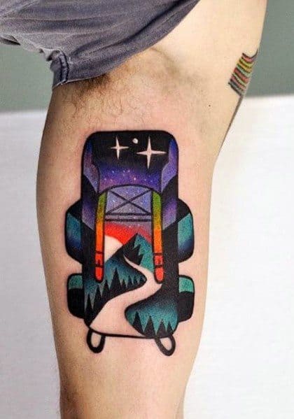A colorful tattoo of a backpack with a scenic mountain trail, sunset, and starry sky inside, symbolizing adventure and exploration.