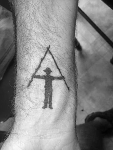 Minimalist Appalachian Trail tattoo with a hiker forming the iconic 'A' symbol, representing adventure and the love of hiking.