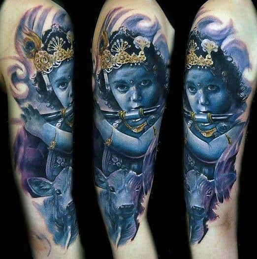 Vivid Krishna tattoo showing a blue-skinned child Krishna playing the flute, with lifelike eyes, golden ornaments, and a cow in the background.
