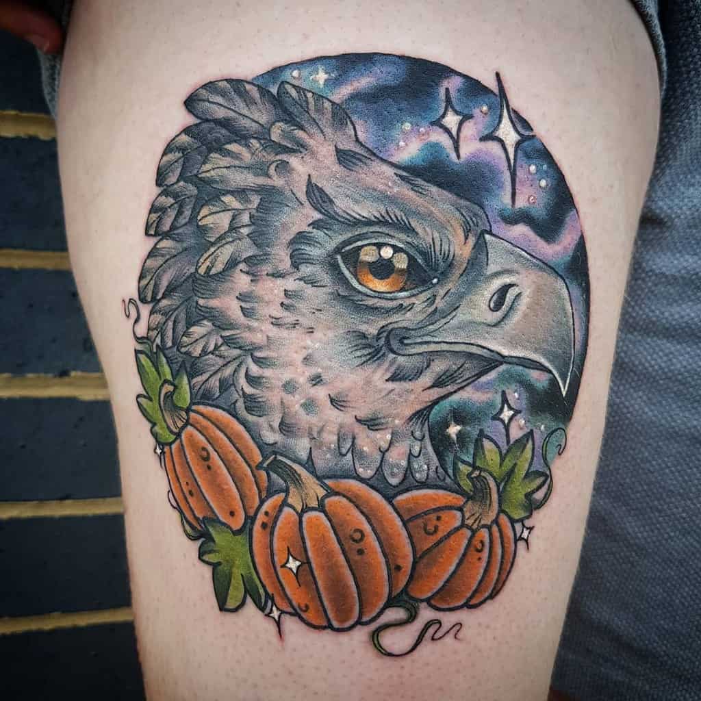 Colorful tattoo of Buckbeak the hippogriff with a cosmic background, sparkling stars, and pumpkins surrounding him.