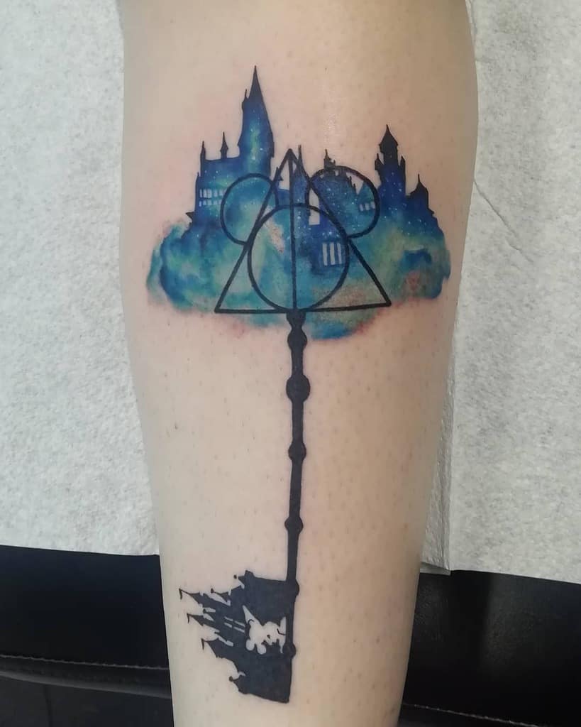 Fusion tattoo of Kingdom Hearts and Harry Potter, featuring a Keyblade with Hogwarts, the Deathly Hallows symbol, and Disney’s Mickey head.