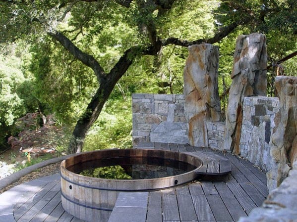 backyard key style hot tub wood deck stone wall