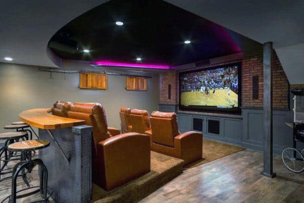 Home theater with leather recliners, a large screen showing basketball, and a bar under ambient purple lighting