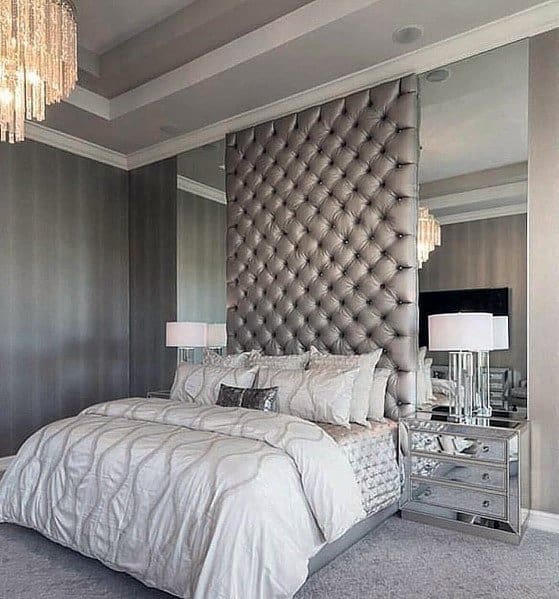 elegant master bedroom with large vertical headboard 