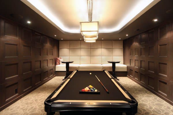 Elegant billiard room with black pool table, wood-paneled walls, and plush built-in seating.