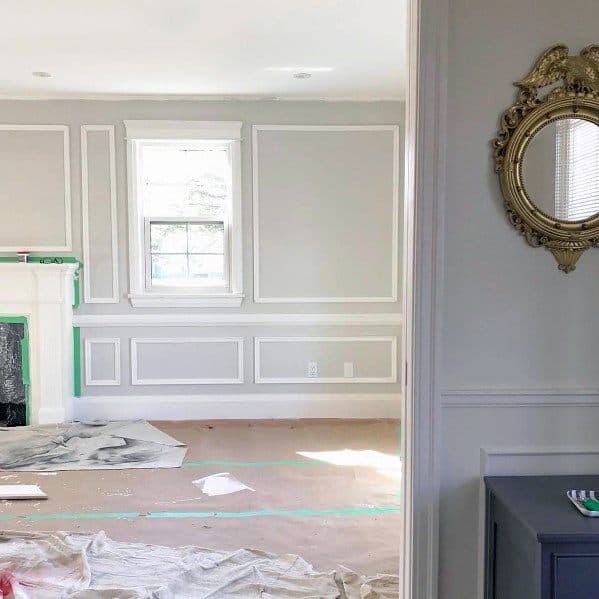 Classic living room with white chair rail molding, light gray walls, and an elegant fireplace centerpiece for a timeless design