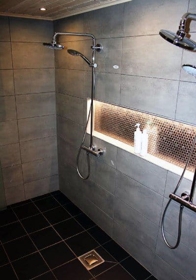 Contemporary shower with dual showerheads and a well-lit niche shelf featuring sleek LED lighting for a modern touch