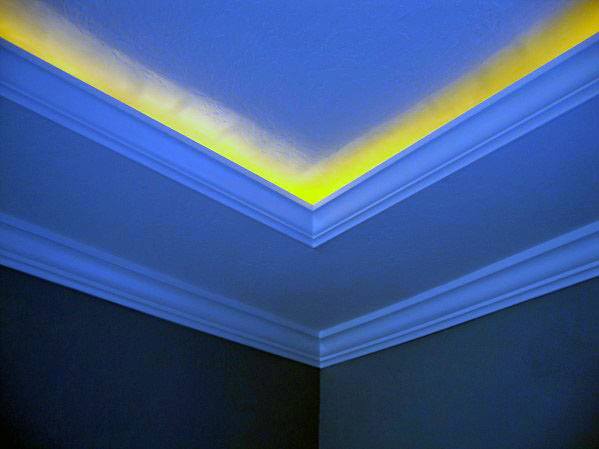Vibrant room with blue and yellow LED crown molding lighting, adding a unique and modern touch