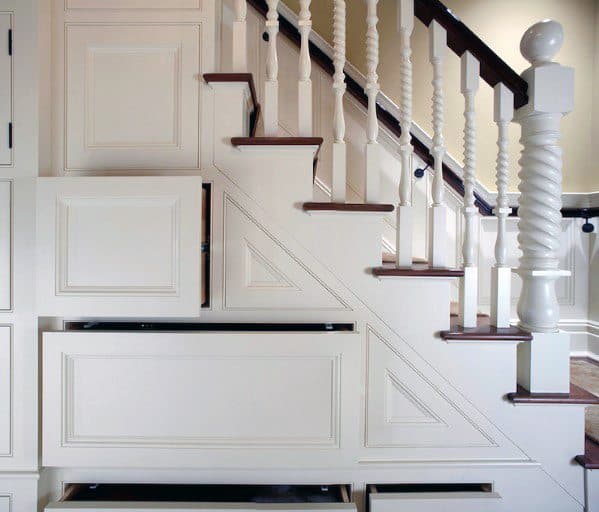 Staircase with built-in storage drawers under the steps in a classic home interior design.