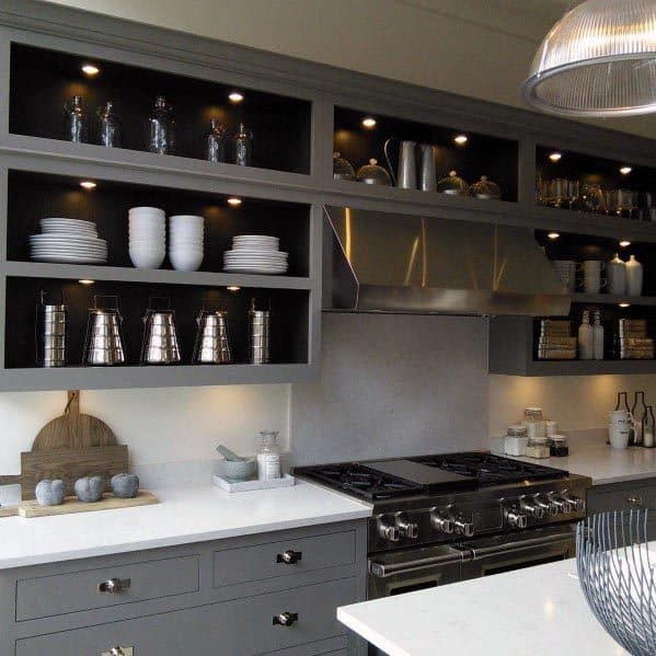 Modern grey kitchen with open shelves, stainless steel range, and under-shelf lighting.
