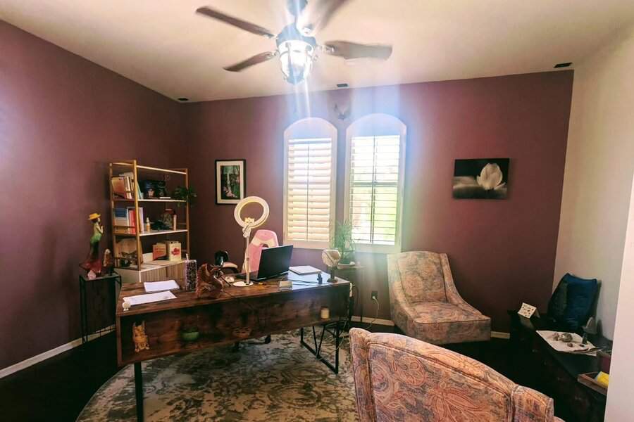 A workspace with warm purple walls creating a cozy, inviting atmosphere that enhances focus and relaxation.