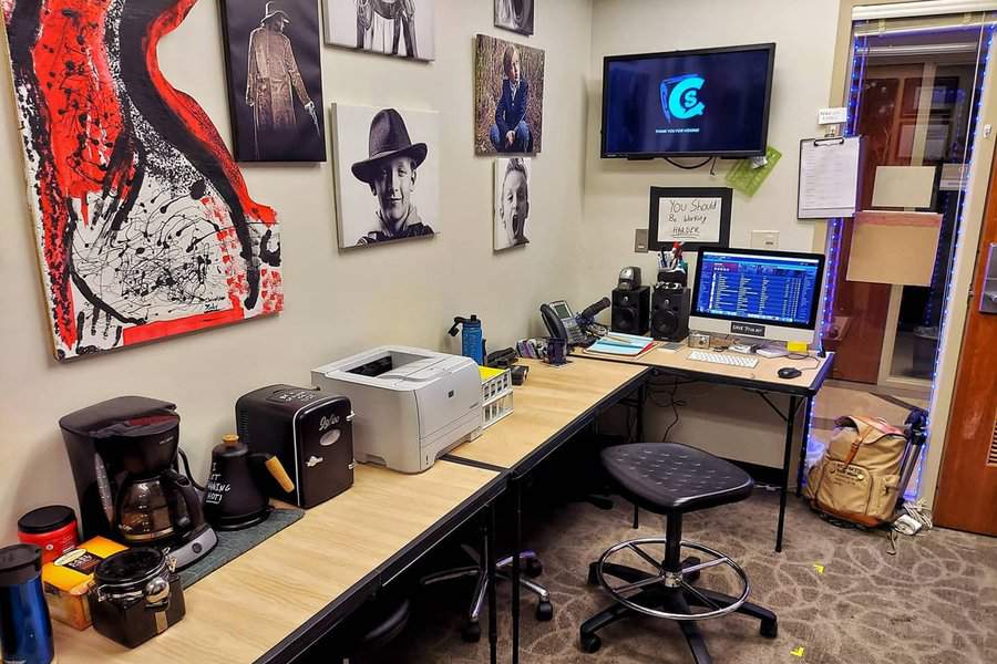 Organized workspace with designated spots for essentials like coffee makers and printers, reducing clutter and promoting efficiency.