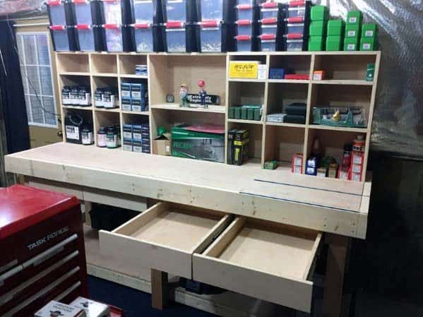 Custom-built reloading bench with spacious shelves, organized storage bins, and large drawers for reloading supplies