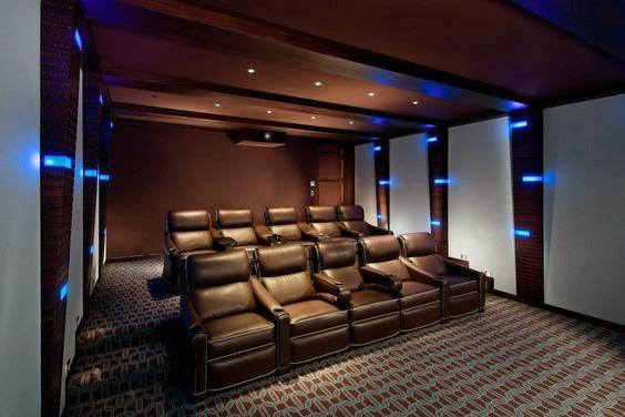 lightbox sconces and brown leather recliners in home theater