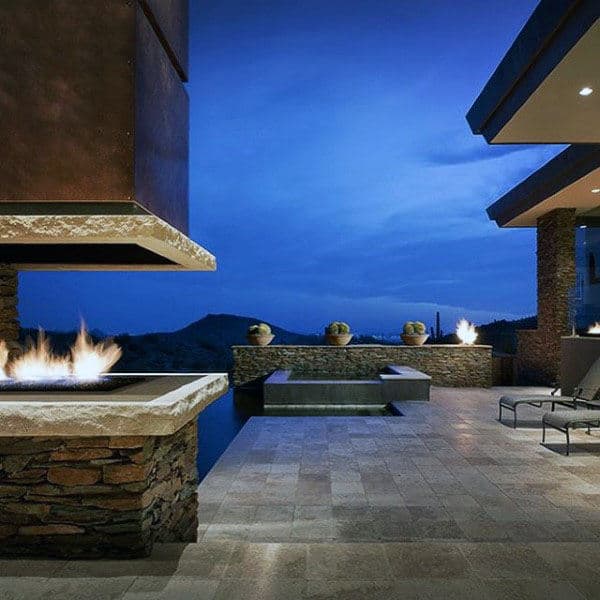 Modern patio with fire features and mountain view at dusk