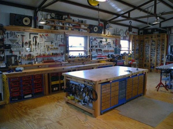 home workshop full of hanging tools wood workbench