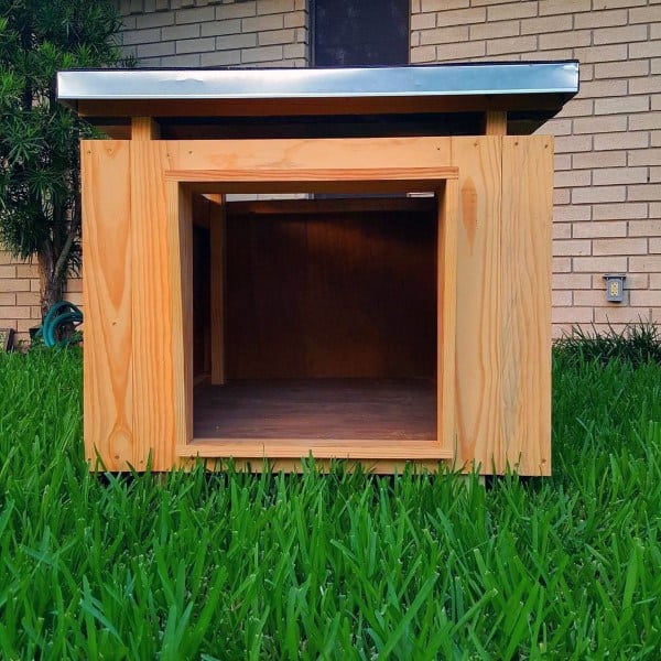 Wooden doghouse with a metal roof