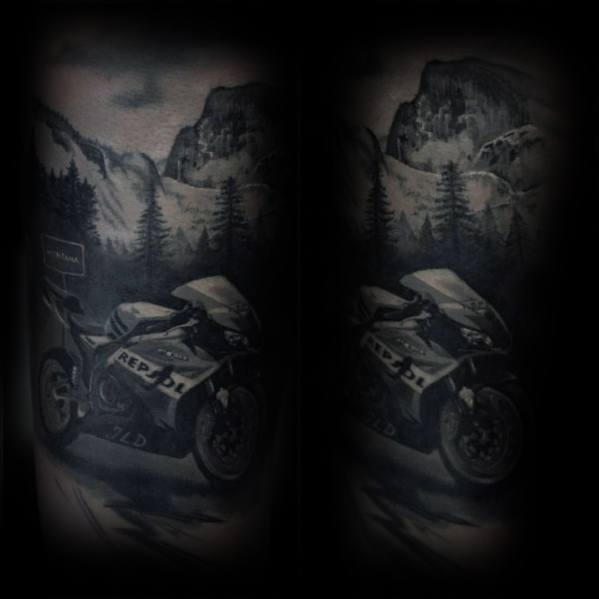 Realistic Honda Repsol motorcycle tattoo with a scenic mountain backdrop, featuring intricate shading and depth for a dramatic effect.