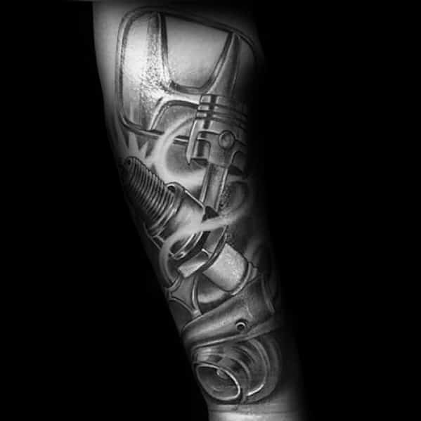 Honda logo tattoo on a man's forearm, integrated with realistic mechanical parts like pistons and spark plugs for a bold, industrial design.