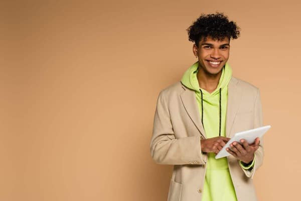Happy,African,American,Man,In,Hoodie,And,Blazer,Holding,Digital