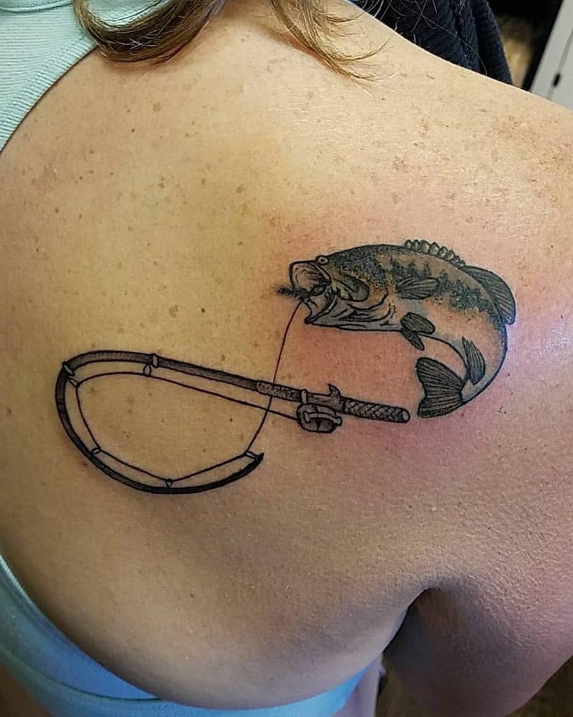 A unique tattoo of a fish biting onto a fishing line, connected to a scythe, blending nature and weaponry in an artistic design.