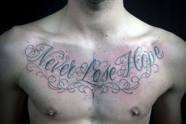 Chest tattoo with cursive script reading "Never Lose Hope" with decorative flourishes