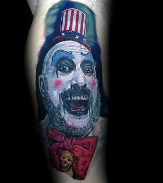 Realistic color tattoo of Captain Spaulding from *House of 1000 Corpses*, featuring his eerie grin, clown makeup, and patriotic hat for a haunting effect.