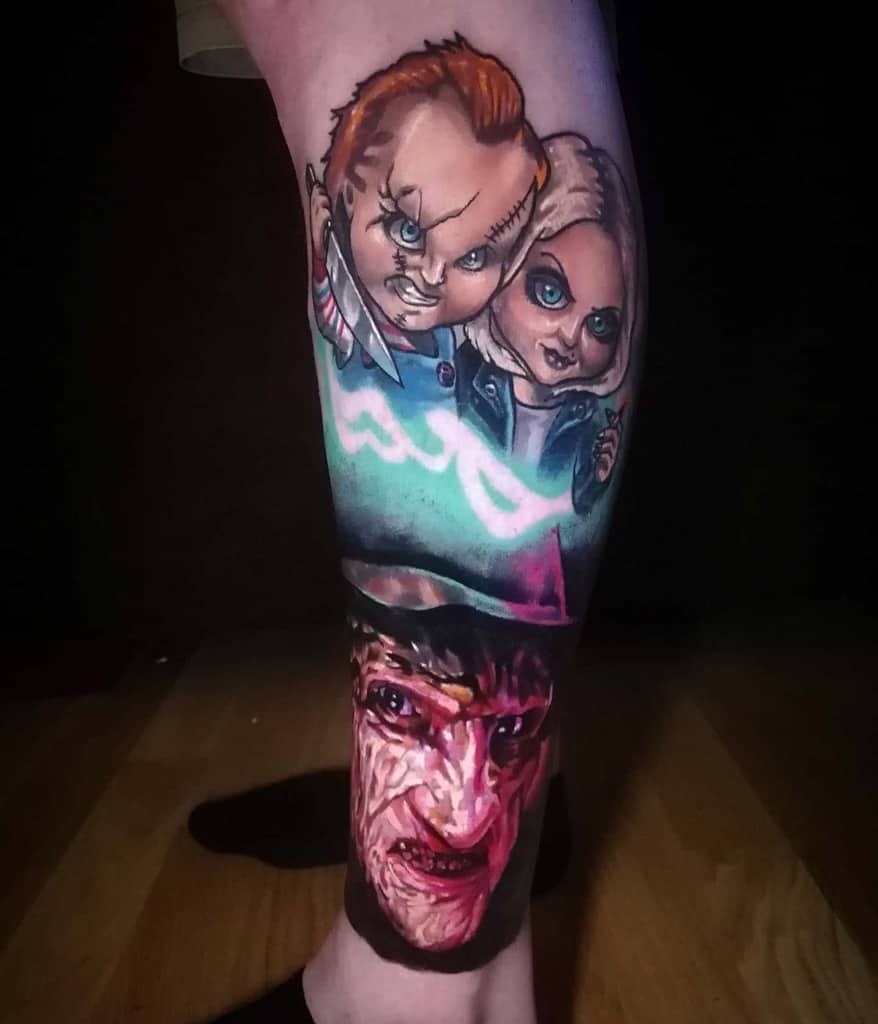 Colorful leg sleeve tattoo featuring the iconic characters Chucky and Tiffany from the Child's Play series, paired with a dramatic, detailed portrait of Freddy Krueger from A Nightmare on Elm Street