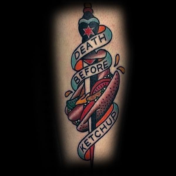 Tattoo featuring a hot dog with the phrase "Death Before Ketchup" wrapped around a sword, adorned with a red star and vibrant details.