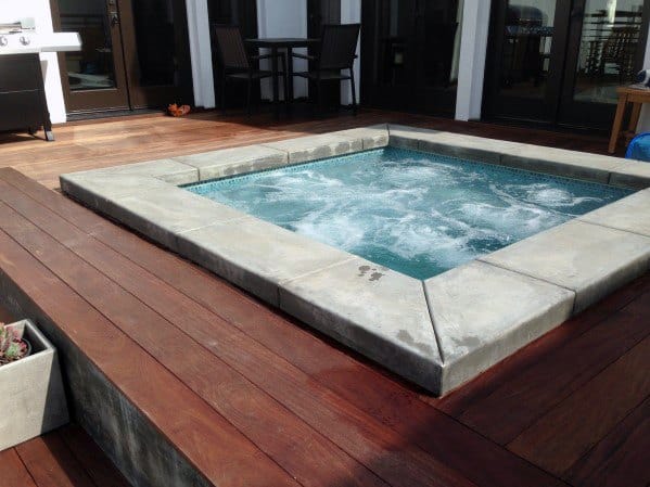 stone edging hot tub wood deck