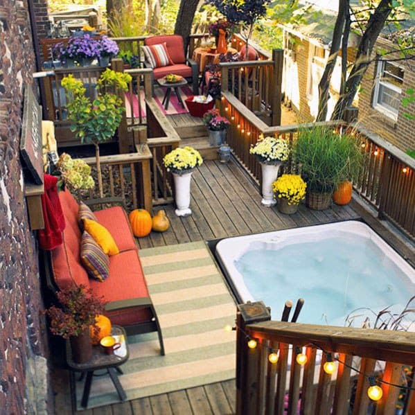 raise wood deck hot tub red lounge and chairs plants