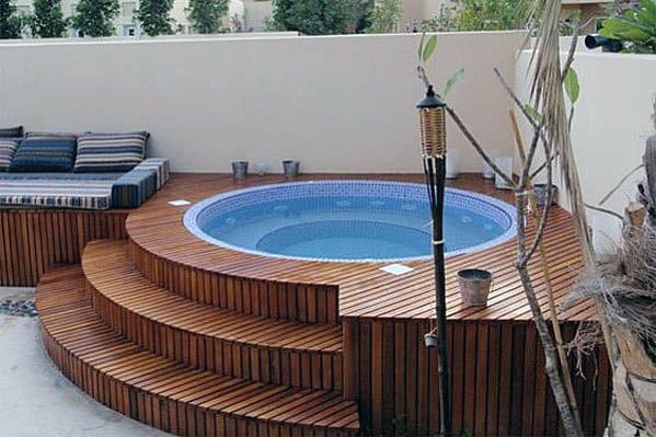wood deck hot tub with stairs and built in seating